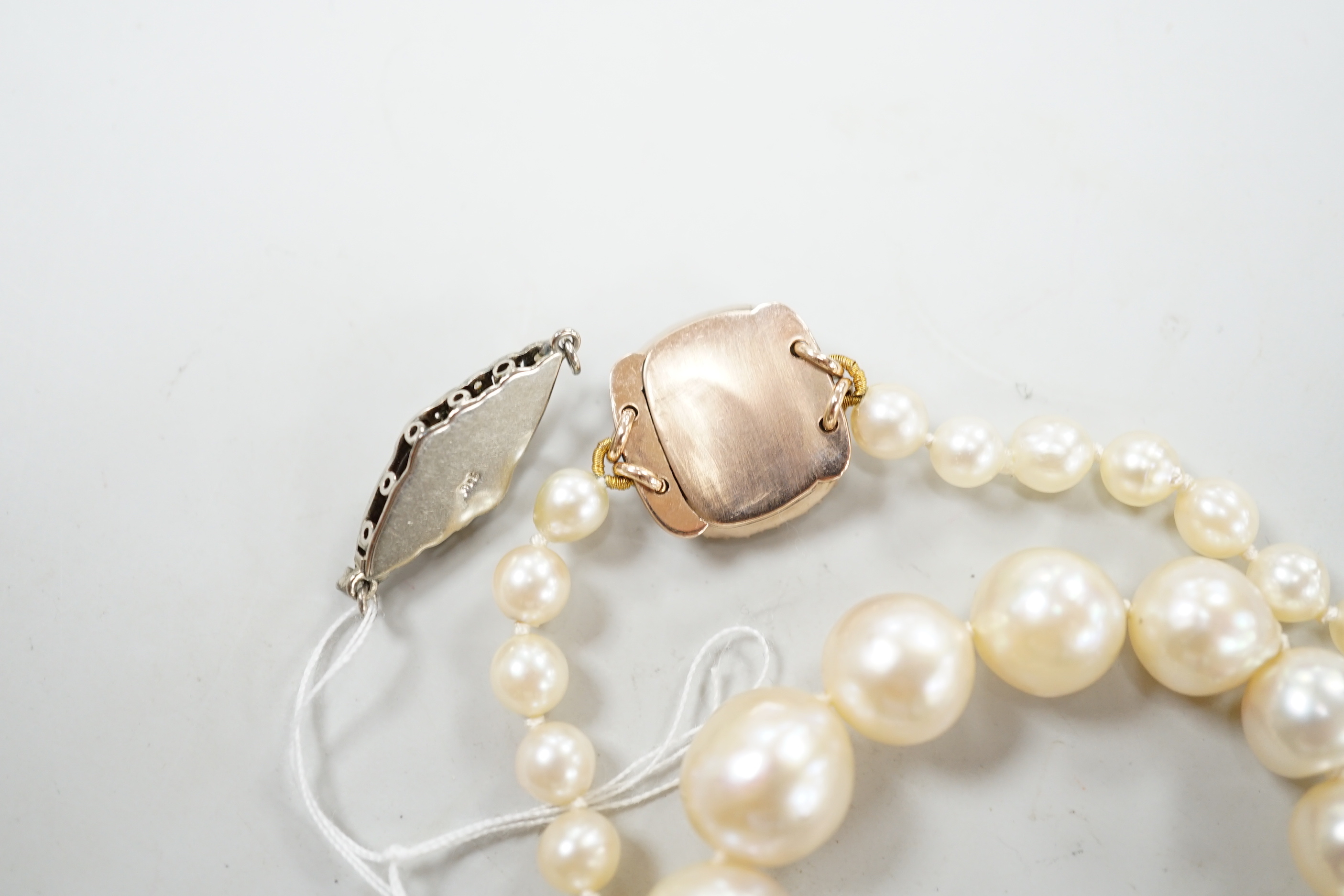 A single strand graduated cultured pearl necklace, now with an earlier 19th century seed pearl and plaited hair set clasp, 76cm, together with original clasp.